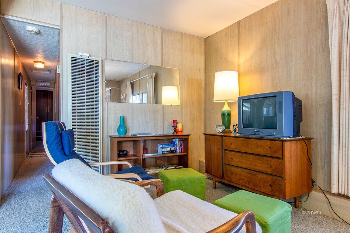 52901 Pine Cove Road, Unit 5 Idyllwild, CA 92549 - Photo 16 of 35 a living room with furniture a flat screen tv and a table