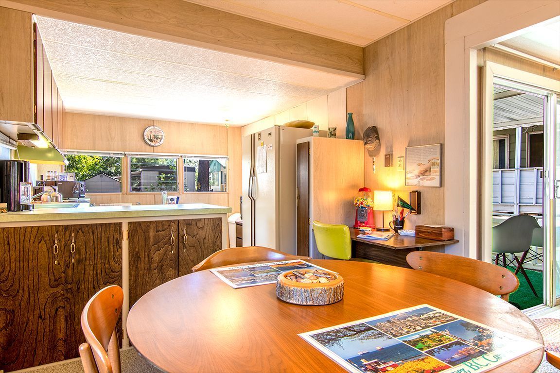 52901 Pine Cove Road, Unit 5 Idyllwild, CA 92549 - Photo 19 of 35 a view of a dining room with furniture a chandelier and wooden floor