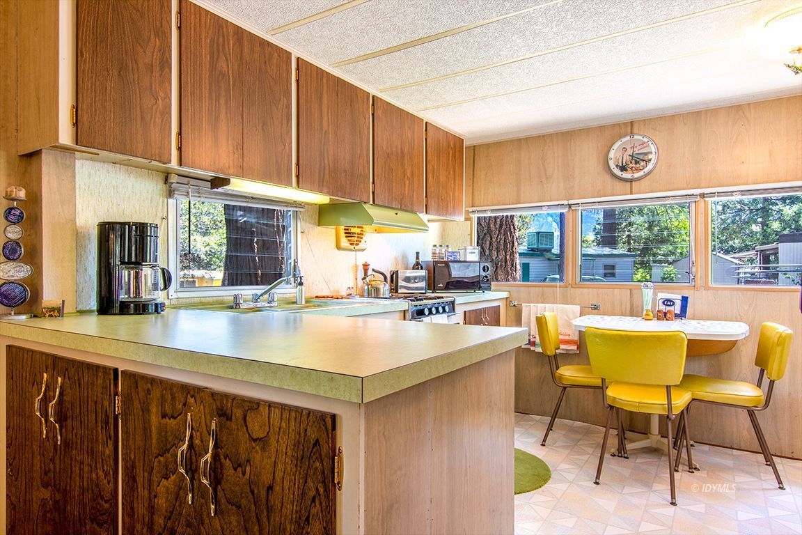 52901 Pine Cove Road, Unit 5 Idyllwild, CA 92549 - Photo 20 of 35 a kitchen with a table chairs and a window