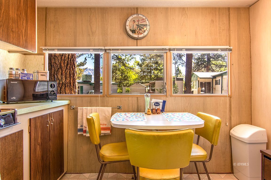 52901 Pine Cove Road, Unit 5 Idyllwild, CA 92549 - Photo 22 of 35 a dining room with furniture and a window