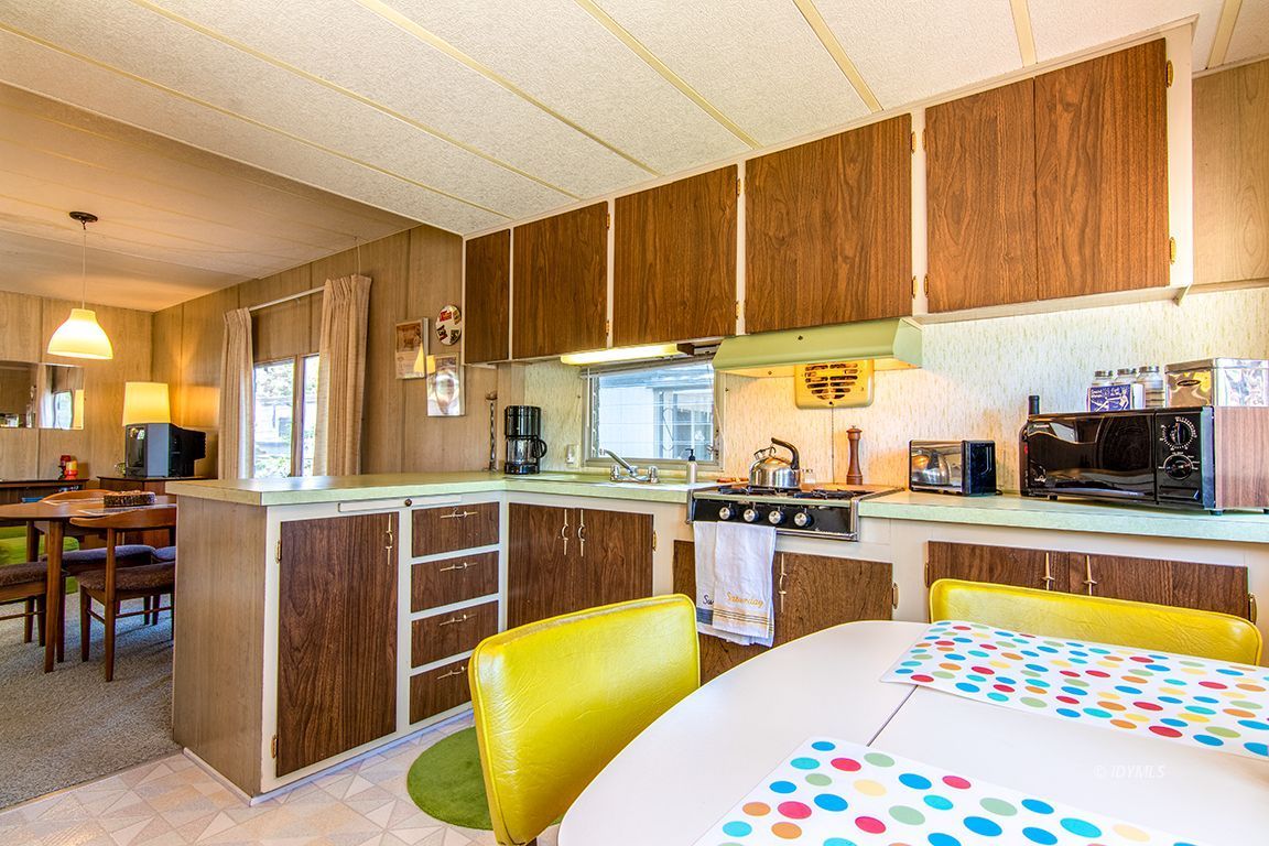 52901 Pine Cove Road, Unit 5 Idyllwild, CA 92549 - Photo 23 of 35 a kitchen with stainless steel appliances kitchen island granite countertop a sink dishwasher stove and cabinets with wooden floor