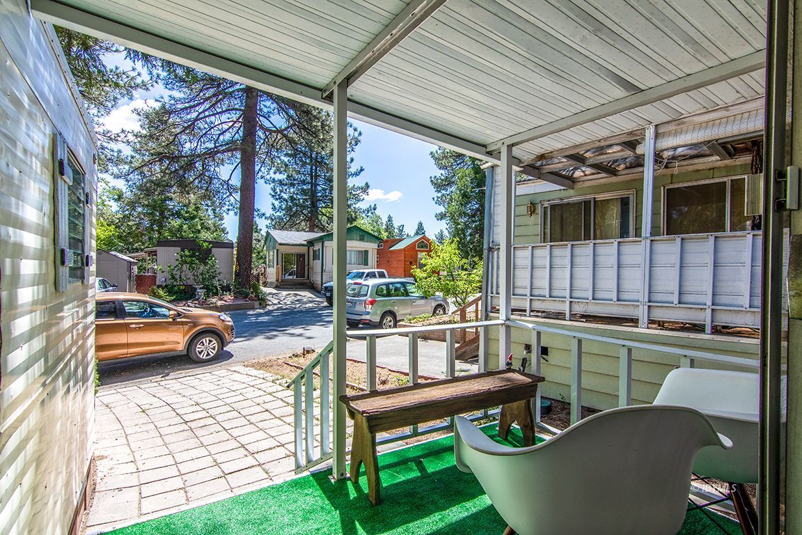 52901 Pine Cove Road, Unit 5 Idyllwild, CA 92549 - Photo 5 of 35 a view of a patio with couches chairs and wooden floor