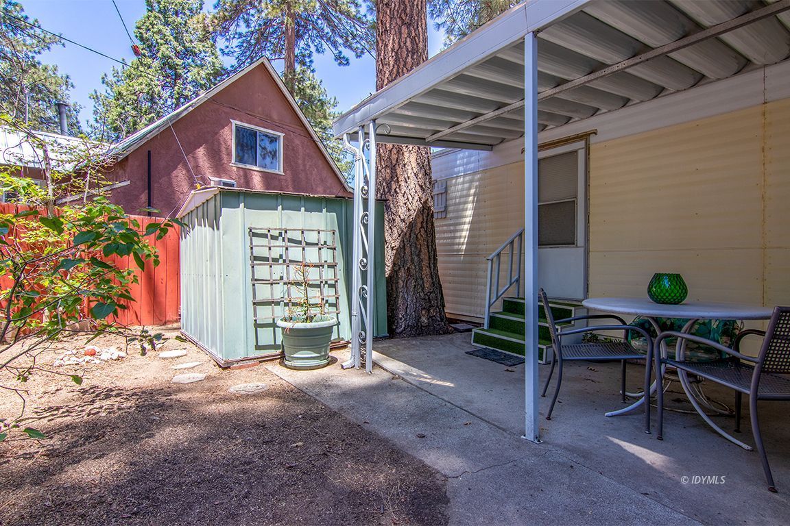 52901 Pine Cove Road, Unit 5 Idyllwild, CA 92549 - Photo 9 of 35 a view of a chairs and table in a backyard