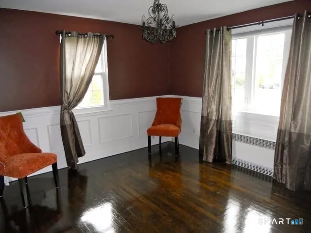 a view of a livingroom with furniture window and wooden floor