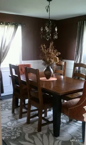 a view of a dining room with furniture and window