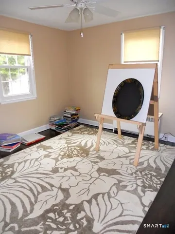 a bedroom with a bed and a chair