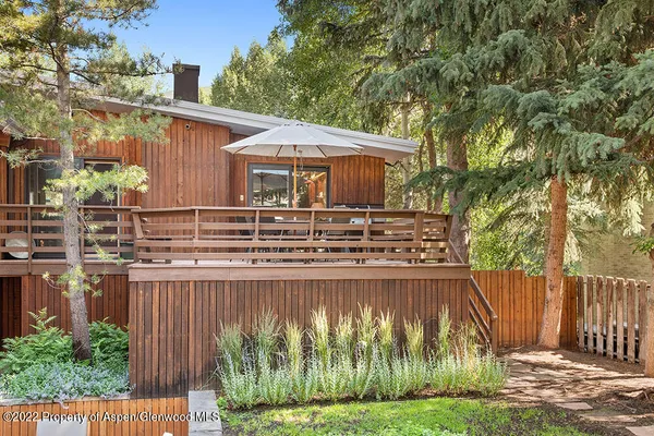 a view of a large building with a big yard and large trees