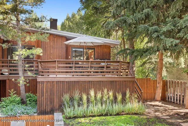 a view of a large building with a big yard and large trees