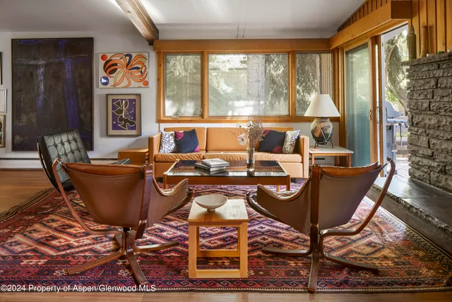 a living room with furniture and large windows