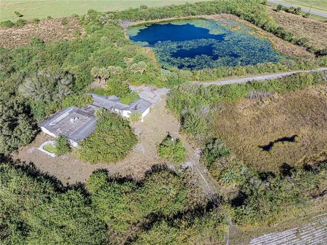 a view of a swimming pool with a yard
