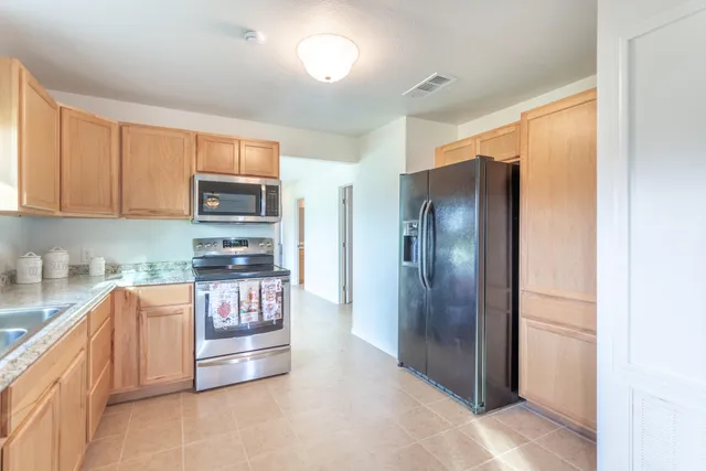 a kitchen with granite countertop a sink cabinets and window