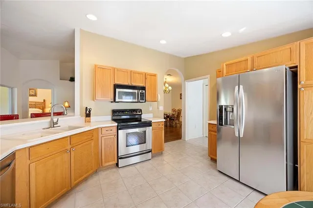 a kitchen with stainless steel appliances granite countertop a refrigerator sink and stove