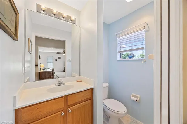 a bathroom with a sink a toilet a mirror and shower
