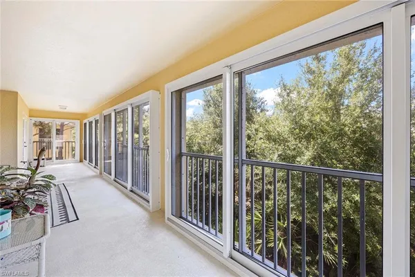 a view of a room with balcony and furniture