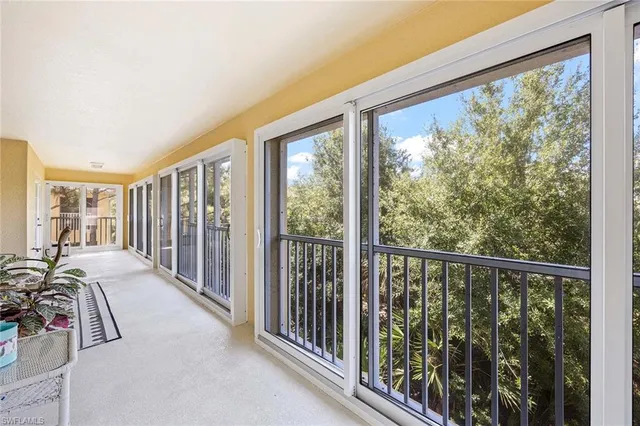 a view of a room with balcony and furniture