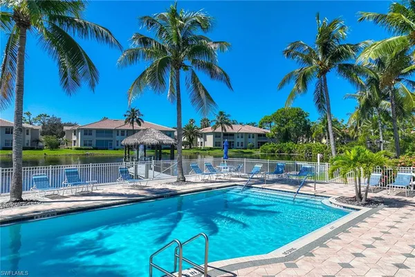a swimming pool view with a seating space
