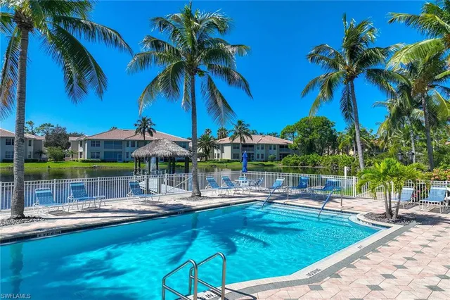 a swimming pool view with a seating space