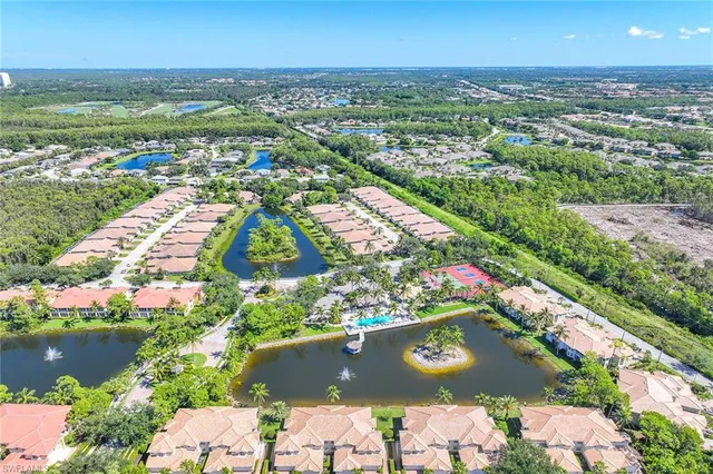 an aerial view of residential houses with outdoor space and river