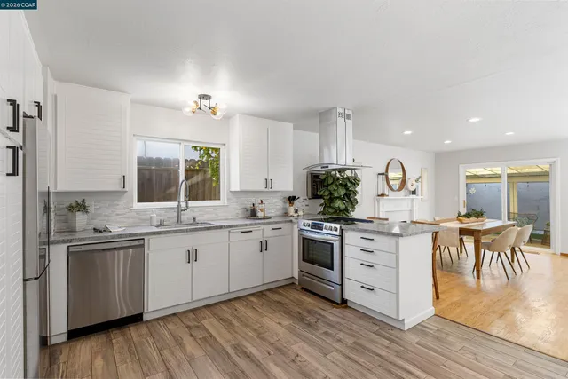 a view of a dining room with furniture and wooden floor