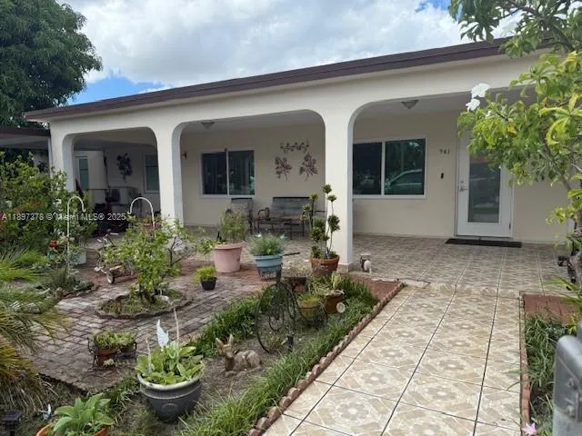 a front view of a house with potted plants