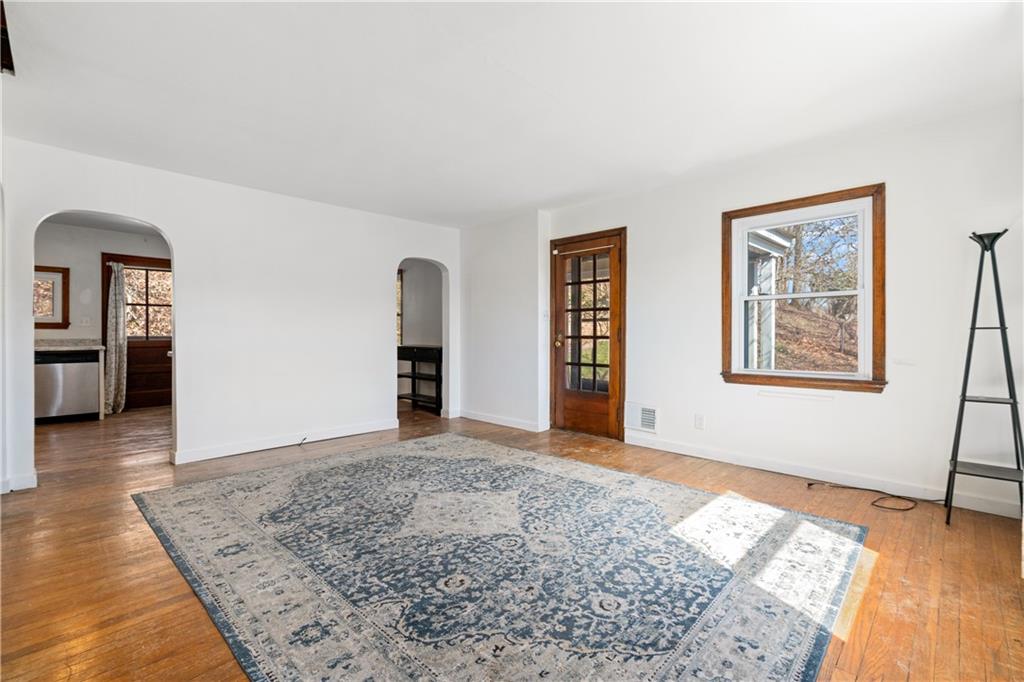 801 Maple Way Oakmont, PA 15139 - Photo 12 of 23 a view of an empty room with window and wooden floor