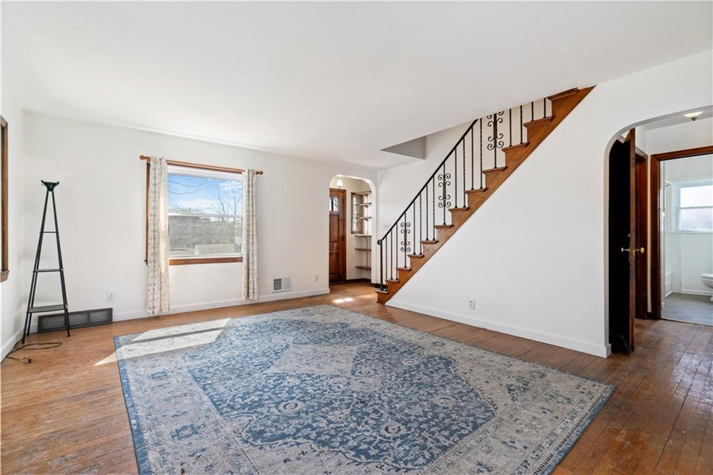 801 Maple Way Oakmont, PA 15139 - Photo 13 of 23 a view of an empty room with wooden floor and stairs