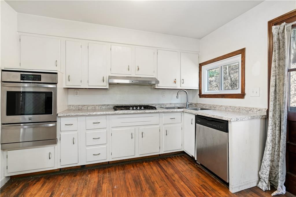 801 Maple Way Oakmont, PA 15139 - Photo 14 of 23 a kitchen with stainless steel appliances granite countertop a stove a sink and a microwave