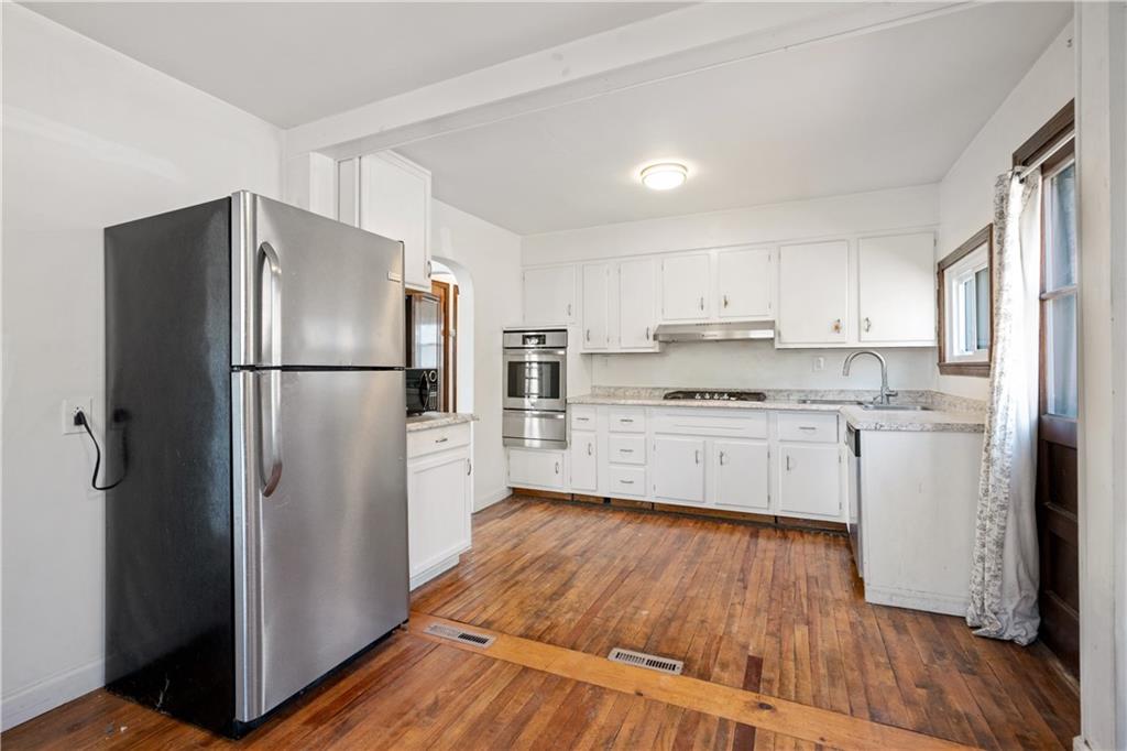 801 Maple Way Oakmont, PA 15139 - Photo 16 of 23 a kitchen with white cabinets and stainless steel appliances