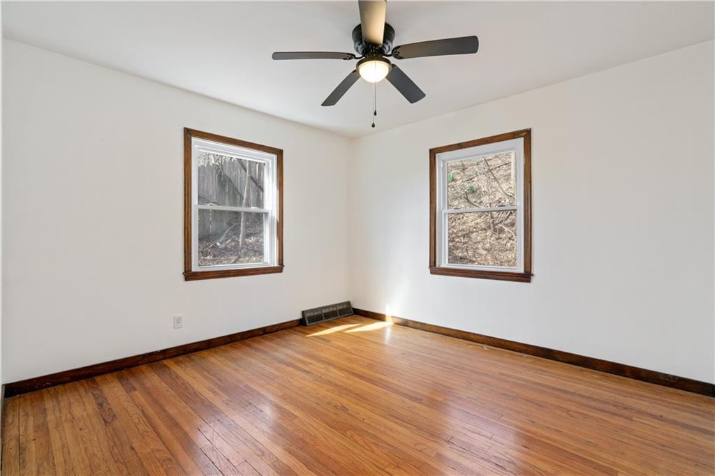 801 Maple Way Oakmont, PA 15139 - Photo 17 of 23 a view of an empty room with window and wooden floor