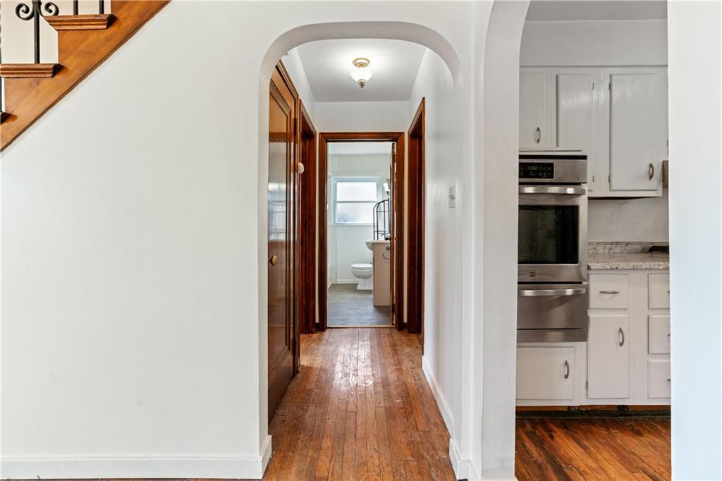 801 Maple Way Oakmont, PA 15139 - Photo 22 of 23 a view of a hallway with wooden floor windows and a kitchen view