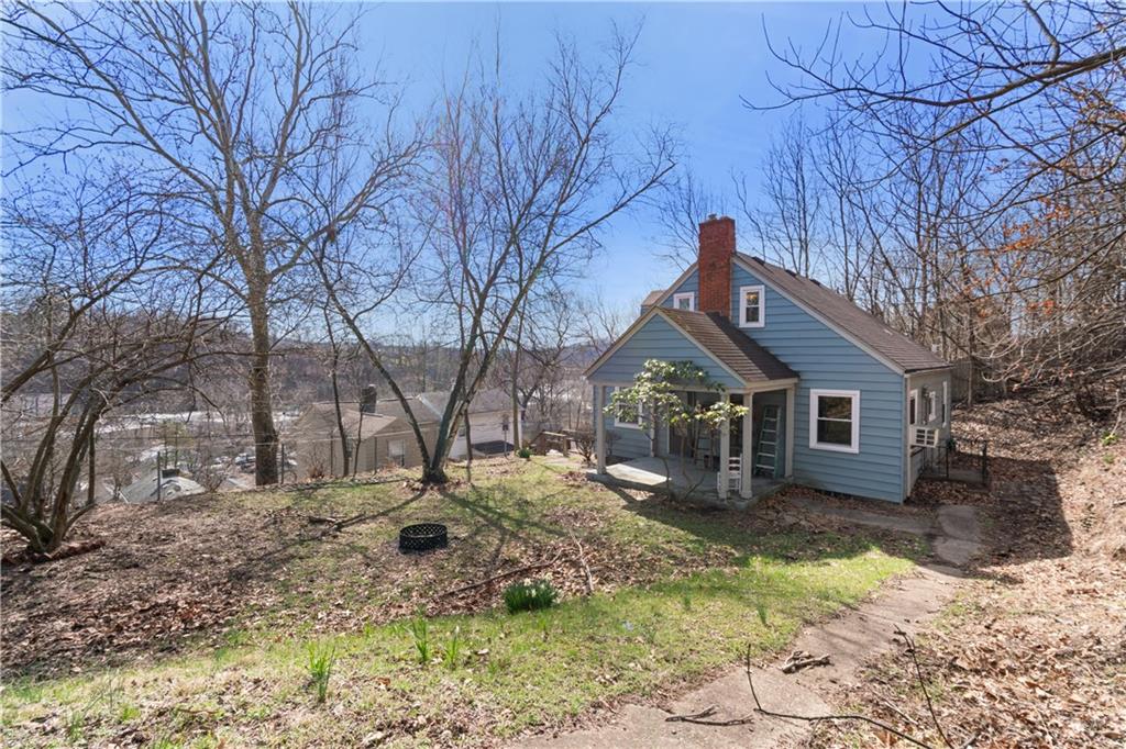 801 Maple Way Oakmont, PA 15139 - Photo 6 of 23 a backyard of a house with large trees and wooden fence