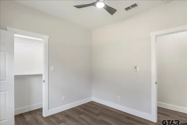 an empty room with wooden floor