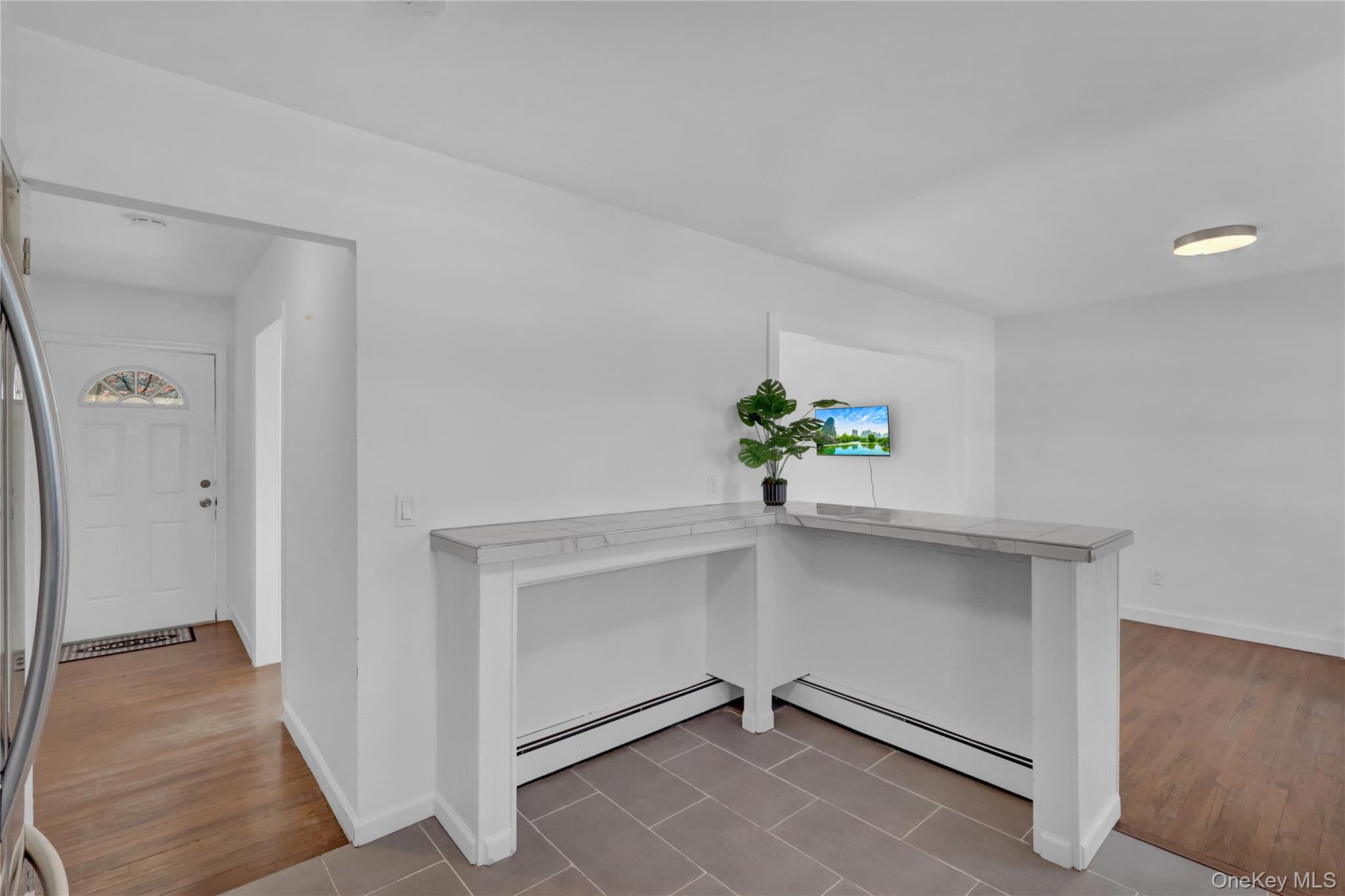 57 Middle Island Road Medford, NY 11763 - Photo 12 of 27 Corridor featuring light wood-type flooring and a baseboard radiator