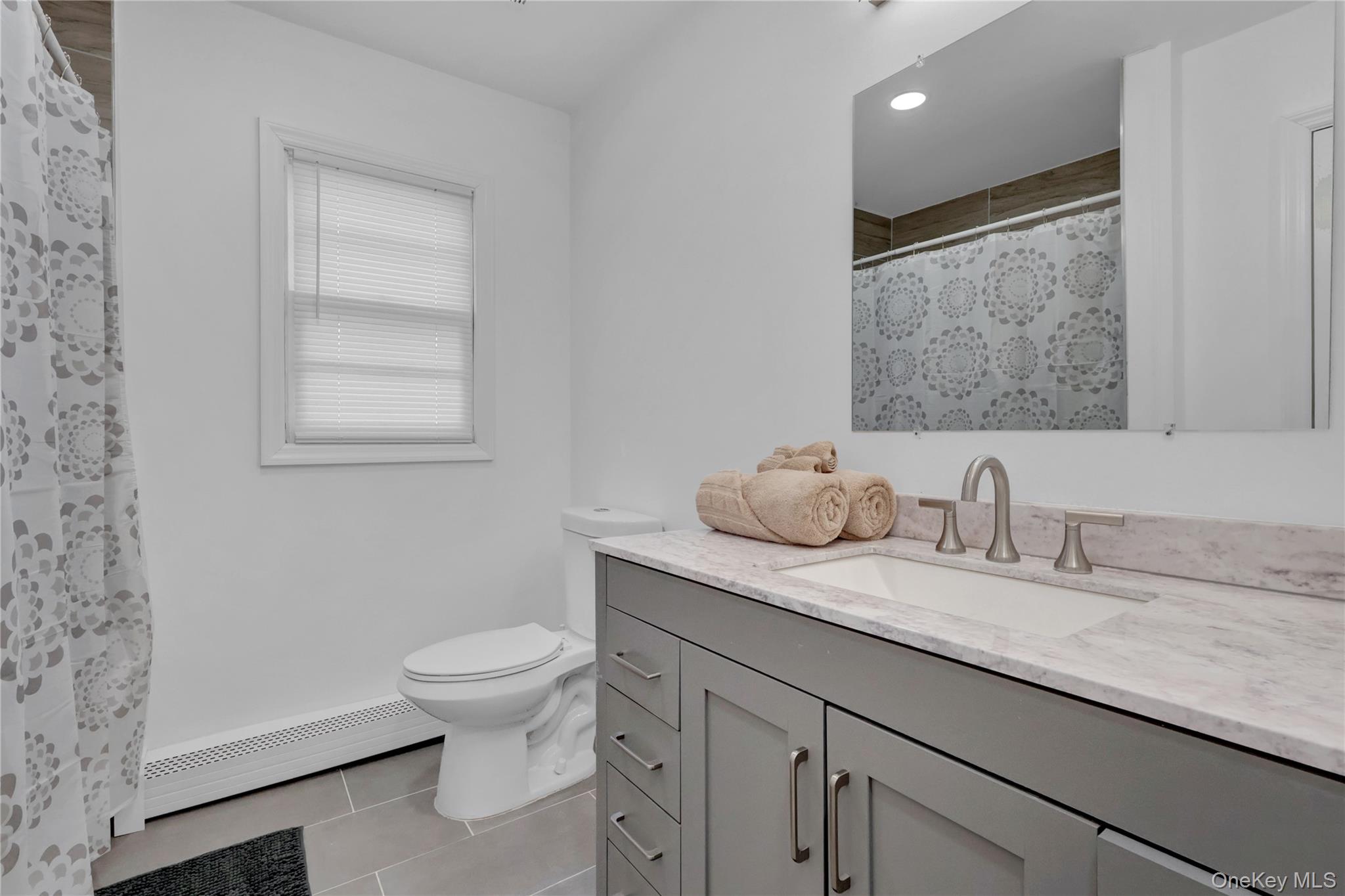 57 Middle Island Road Medford, NY 11763 - Photo 14 of 27 Bathroom with vanity, light tile patterned floors, a baseboard radiator, a shower with shower curtain, and recessed lighting