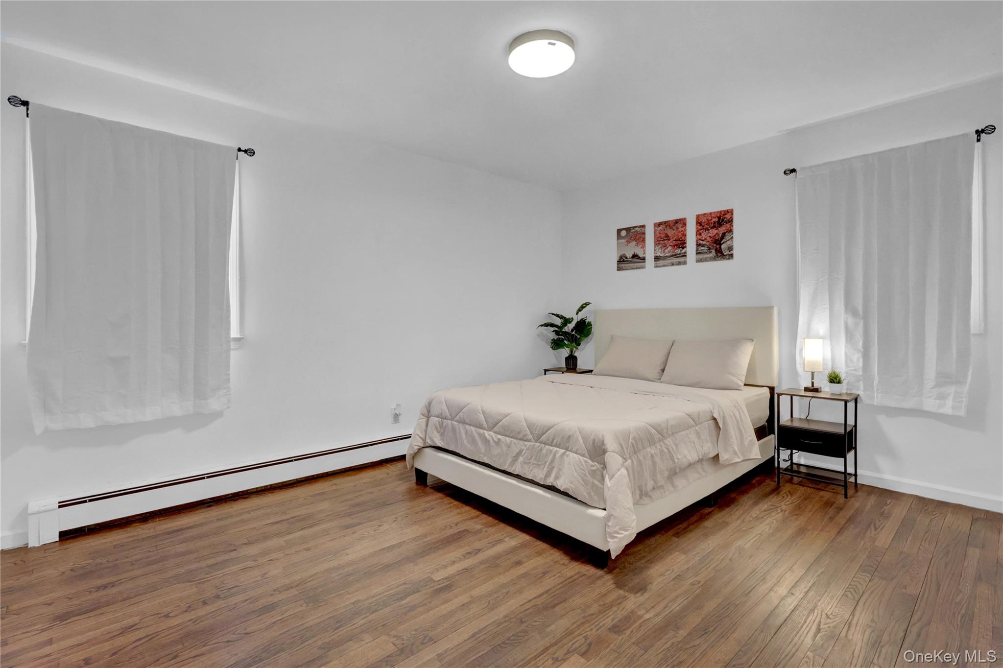 57 Middle Island Road Medford, NY 11763 - Photo 15 of 27 Bedroom with a baseboard heating unit and wood-type flooring