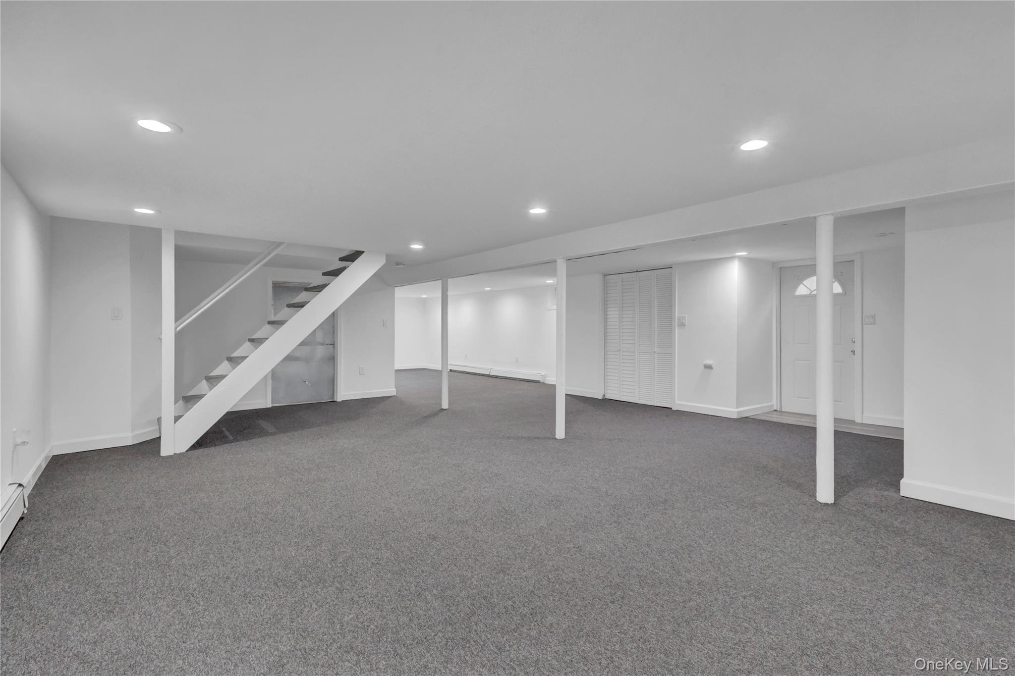 57 Middle Island Road Medford, NY 11763 - Photo 17 of 27 Finished basement featuring carpet floors, recessed lighting, stairs, and a baseboard radiator