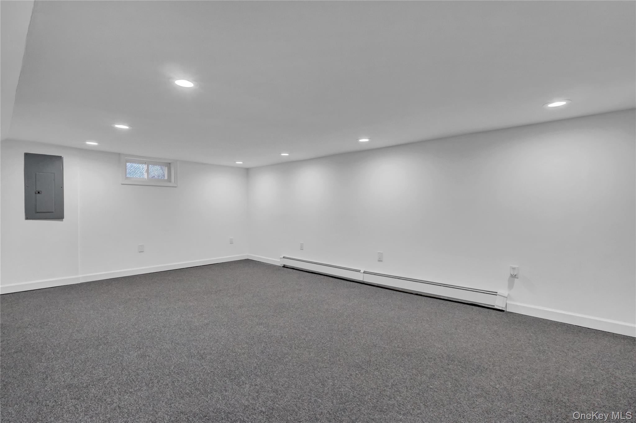 57 Middle Island Road Medford, NY 11763 - Photo 18 of 27 Below grade area featuring baseboard heating, electric panel, carpet, and recessed lighting