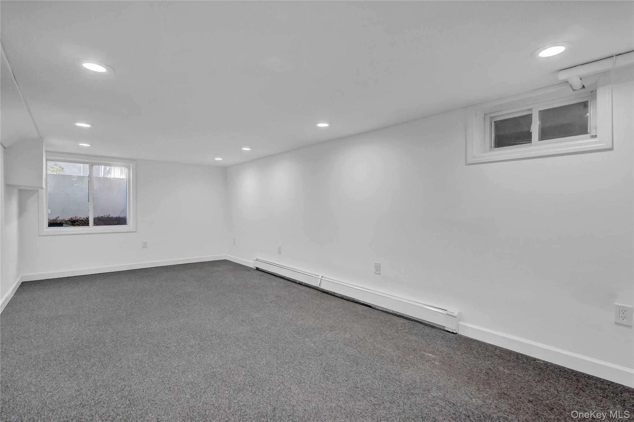 57 Middle Island Road Medford, NY 11763 - Photo 19 of 27 Basement featuring a baseboard radiator, carpet flooring, and recessed lighting