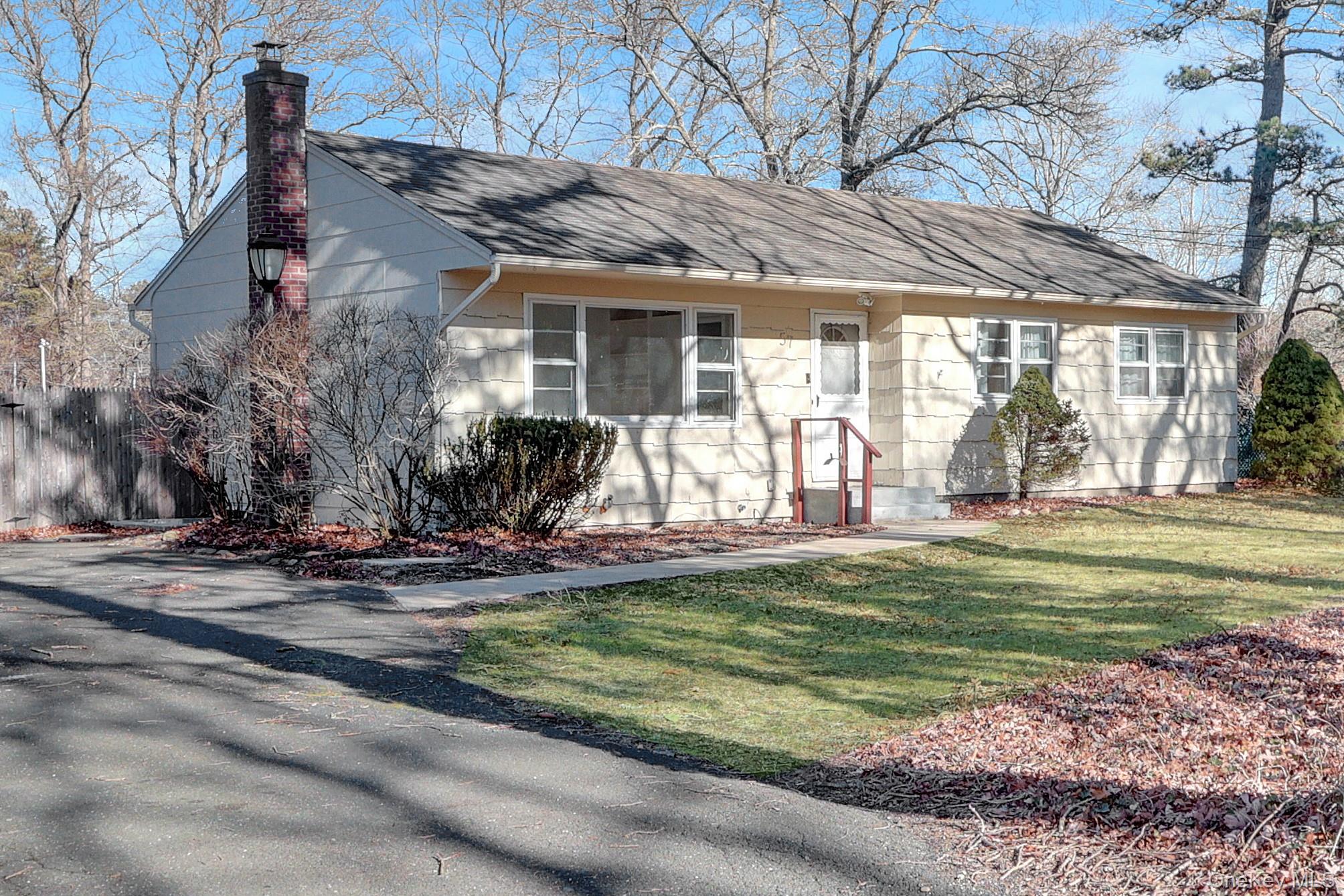 57 Middle Island Road Medford, NY 11763 - Photo 22 of 27 View of front of house featuring a chimney, a front lawn, and a shingled roof