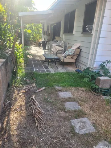 a backyard of a house with outdoor seating