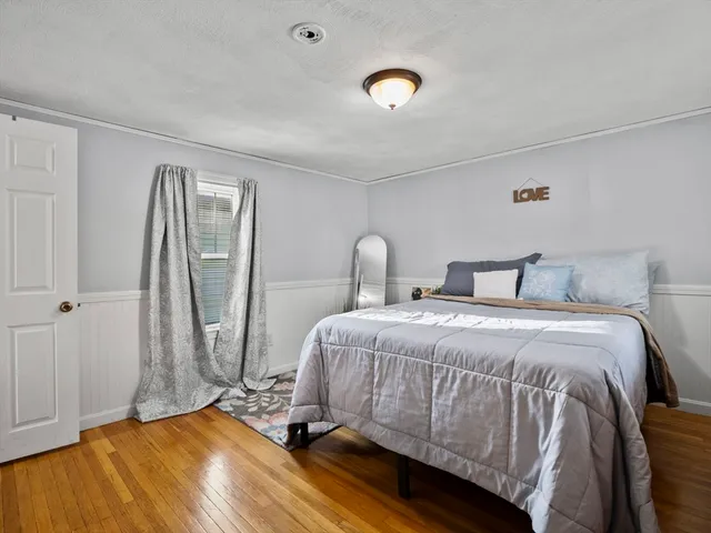 a bedroom with a bed and a mirror