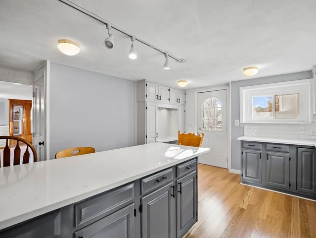 a kitchen with a sink a stove a dining table and chairs