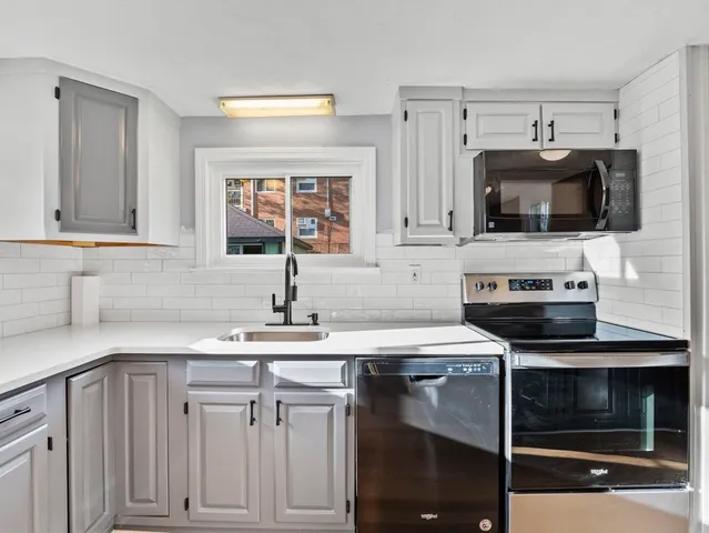 a kitchen with cabinets stainless steel appliances and a counter space