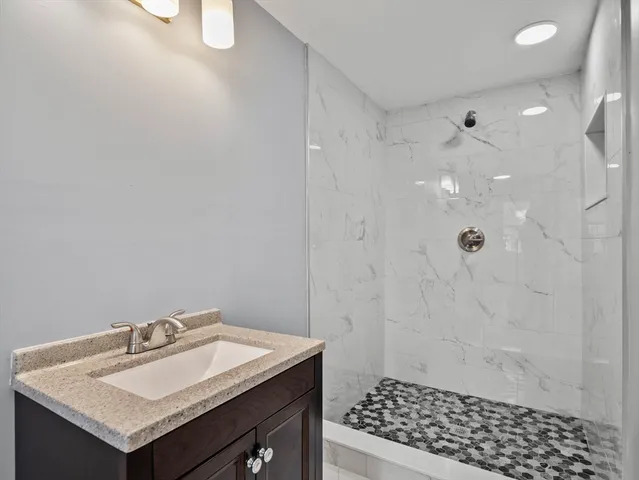 a bathroom with a sink toilet and shower
