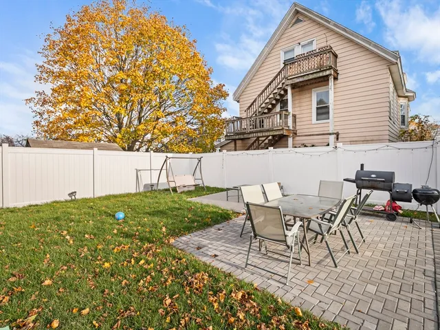 a view of backyard of house with seating space
