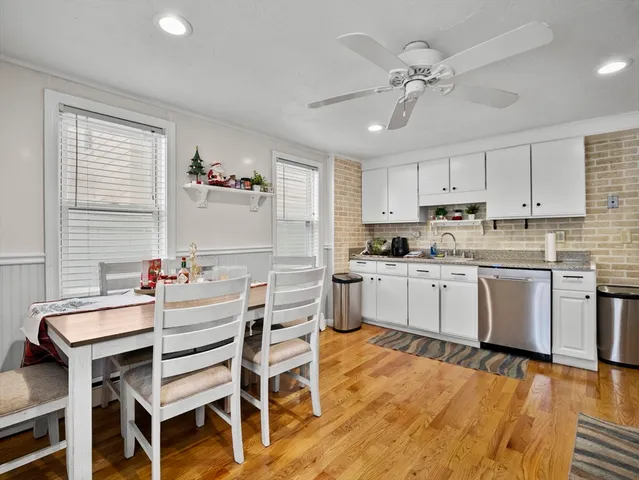 a kitchen with a table chairs microwave and cabinets