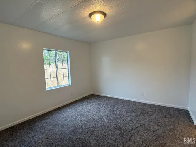 an empty room with a empty space and windows