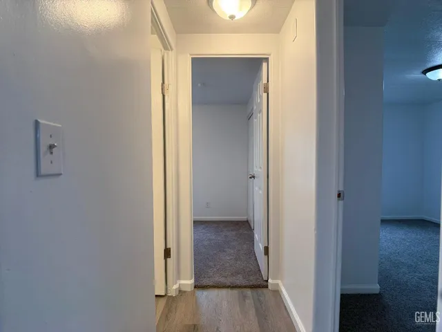 a view of a hallway with wooden floor