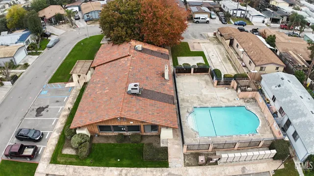 an aerial view of a house with a yard and potted plants