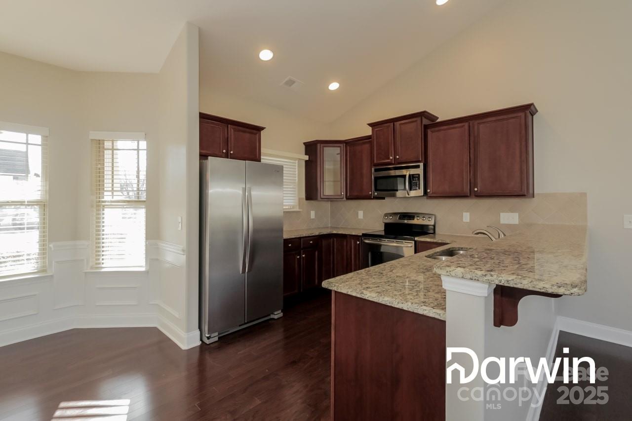 147 Water Ski Drive Statesville, NC 28677 - Photo 4 of 12 a kitchen with granite countertop stainless steel appliances and wooden cabinets